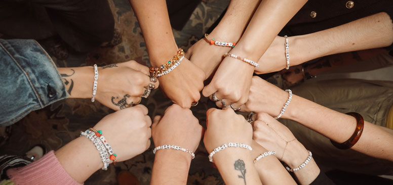 Hands in circle, bracelets